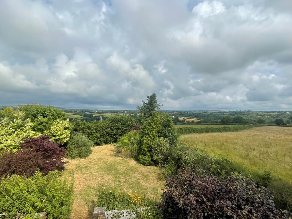 Lot: 123 - DETACHED CHALET BUNGALOW FOR IMPROVEMENT - Photo taken from first floor room showing rear view.